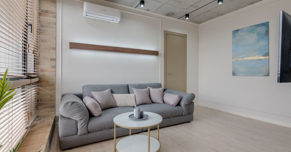 Unité de climatisation murale installée dans une pièce à vivre de maison